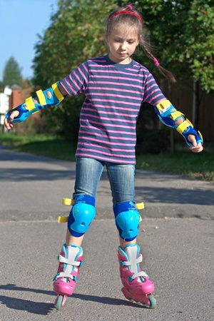 girl riding on roller blades on summer holidays の写真素材