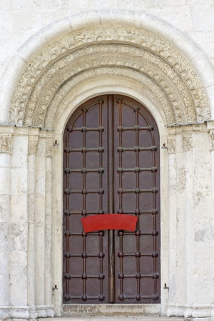 old door and white stone carvings, ancient church, Russia の写真素材
