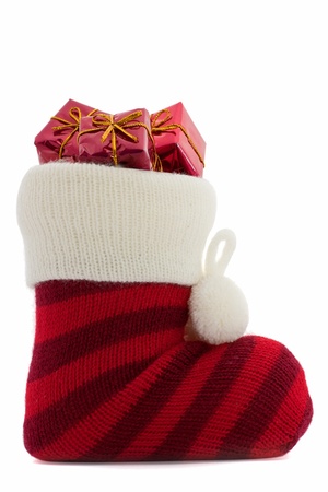 christmas stockings with presents over white background の写真素材