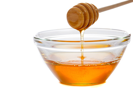 Honey  with dipper and glass bowlの写真素材