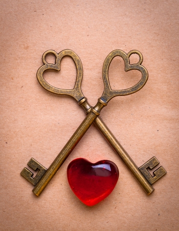 two keys and heart over old paperの写真素材