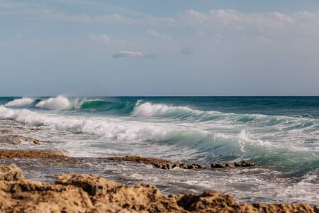 High waves beat against the shore. Turquoise sea water in a stormの写真素材