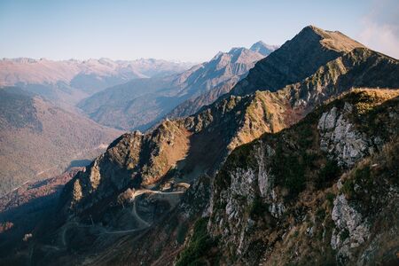 Sochi, Krasnaya Polyana. View of the Caucasus mountains. Serpentine road on the topの写真素材