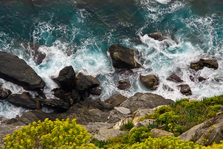 Rocks in the sea. View down the cliffの写真素材