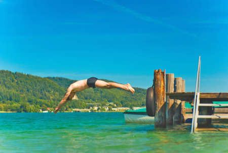 Diving man in a beautiful lakeの写真素材