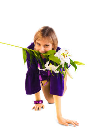 Young blonde on her knees with flowers in her mouthの写真素材