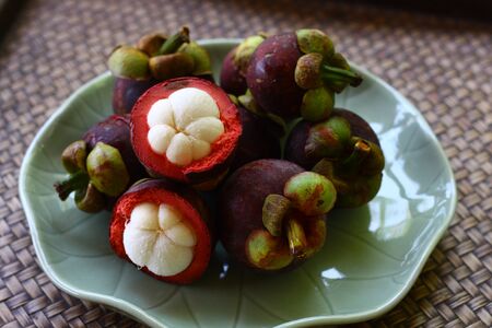 Mangosteen in the green ceramic dishの写真素材