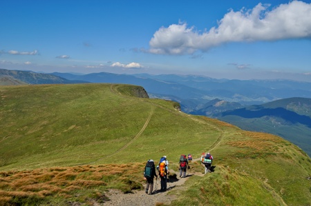 Tourists on the hiking trip in the Carpathian Mountains 