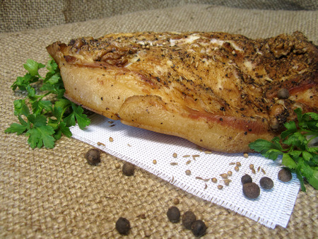 large piece of bacon with parsley and spicesの写真素材