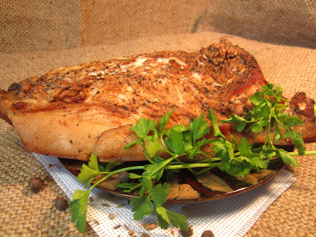 large piece of bacon with parsley and spicesの写真素材