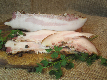 slices of smoked bacon with parsley and spicesの写真素材