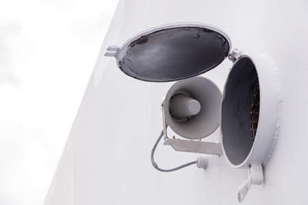 White megaphone, loud speaker close-up. Hanging on the wall. High quality photoの写真素材