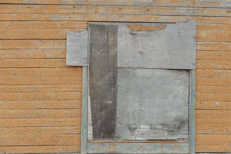 View of a part of the wall of an old wooden building. window. House walls made of painted boards. High quality photoの写真素材
