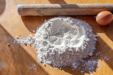 flour, egg, rolling pin on the table. Cooking concept. High quality photoの写真素材