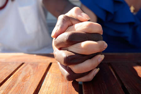 Hands joined together, close-up, different races. High quality photoの写真素材