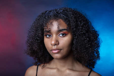 Portrait of a black girl in the studio on a dark background. High quality photoの写真素材