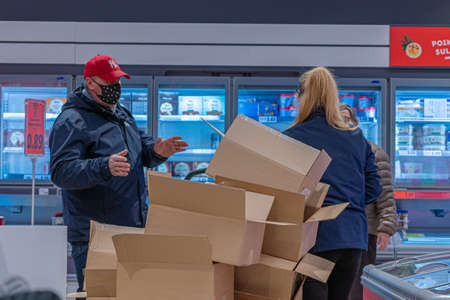 Espoo, Finland, November 7, 2020 Shoppers wearing medical masks in a supermarket. Concept protecting...