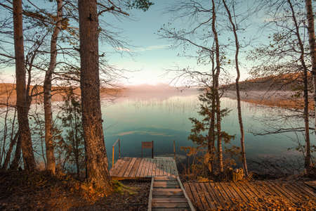 Exit to the lake through the pier. Early morning in October. High quality photoの写真素材