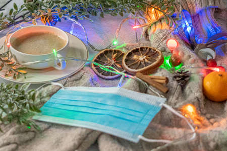 Medical mask and accessories for the New Year, green twig, dry oranges, Czech woman with coffee,...