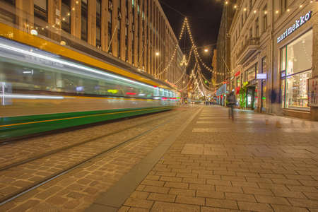 Helsinki, Finland November 22, 2020 Senate Square. Blurred public transport traffic, tram in the city center at night. Long exposure. High quality photoのeditorial素材