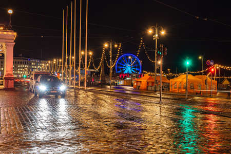 Helsinki, Finland November 30, 2020 Old town streets in the evening, decorated for Christmas, after the rain. Burning lights and reflections. High quality photoのeditorial素材