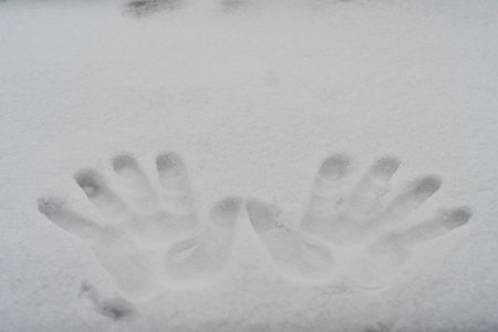 Handprints in the snow. close-up. Hello winter concept. High quality photoの写真素材