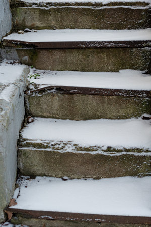 The stone staircase is covered with snow. Concept, winter has come, cautiously slippery. High quality photoの写真素材