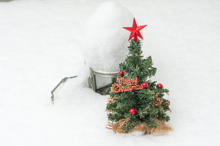 Decorative, small herringbone. and a lantern for a candle in the snow there is a place for text. Christmas, New Year concept. High quality photoの写真素材