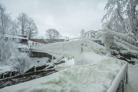 Waterfall in winter, strong current, frozen ice and trees in other. landscape photography Frost,...
