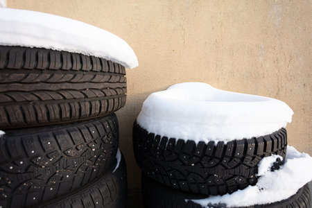 Old tires under white snow. High quality photoの写真素材