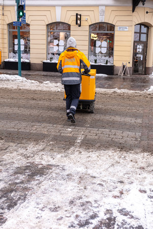 Finland, Helsinki. January 26, 2021 A male postman in overalls delivers mail. High quality photoの写真素材