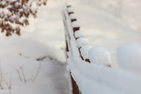 Iron fence covered with snow in winter. High quality photoの写真素材