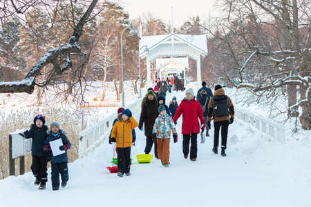 Seurasaari, Helsinki. Finland January 31, 2021. People walk across the bridge. Healthy lifestyle concept. Walk to the sea. High quality photoのeditorial素材