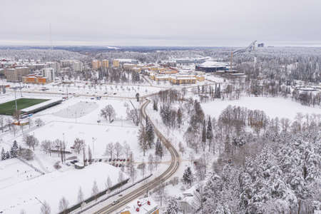 Lahti, Finland February 14, 2021. Photo from the drone. City view, residential buildings and streets covered in snow, partly forested area. The day is cloudy, winter. High quality photoのeditorial素材
