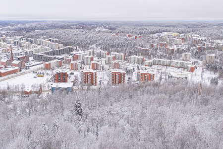 Lahti, Finland February 14, 2021. Photo from the drone. City view, residential buildings and streets covered in snow, partly forested area. The day is cloudy, winter. High quality photoのeditorial素材