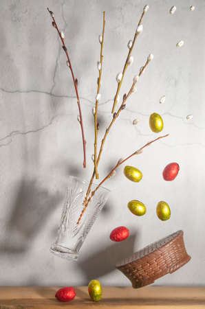 Willow in a vase, chocolate eggs and a basket. Levitation, Concept, congratulation, postcard for...