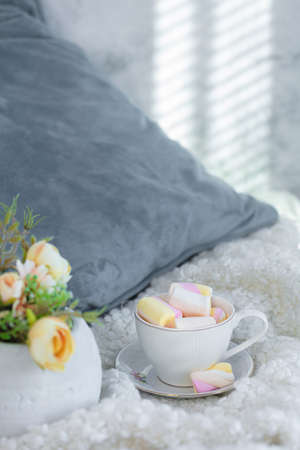 Pillow, a cup of coffee, flowers, Marshmallow Still life, layout on the bed. High quality photoの写真素材