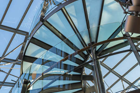 Glass, spiral staircase, a fragment of modern architectureの写真素材