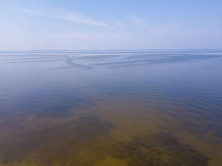 The Gulf of Riga, the Curonian Spit can be seen in the distance. Sunset, quiet summer evening. Photo...