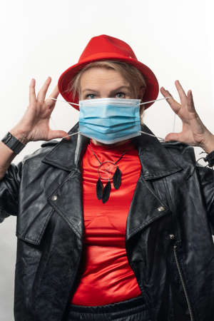 Aged woman in a medical mask on her face. Concept, save, protect your lifeの写真素材