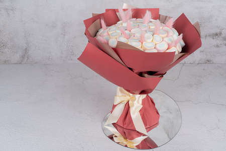 Sweet bouquet of Marshmallows sweets, beautifully decorated, lies on a gray background. There is a place for text Holiday concept, congratulations.の写真素材