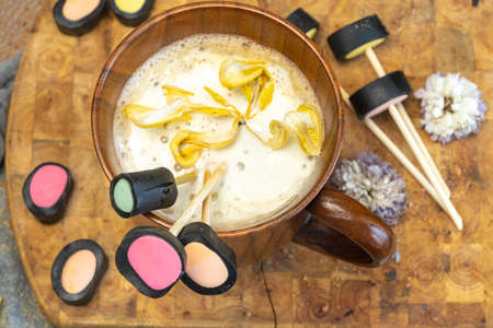 wooden coffee cup, dry yellow flowers, licorice candy, top view, layout,の写真素材