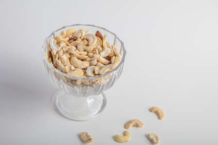 Glass vase with Indian nuts On a white background, Concept, raw food diet, healthy foodの写真素材