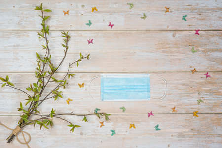 Medical, protective face mask, pussy willow bouquet on a wooden background. There is room for text. Protected from  for shoppingの写真素材