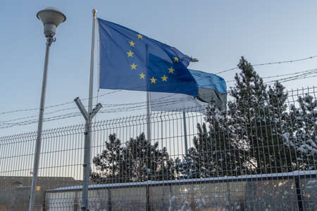 Narva Estonia. December 5, 2021 View of the waving flag of Estonia and Europe, on the border between Estonia and Russiaの写真素材