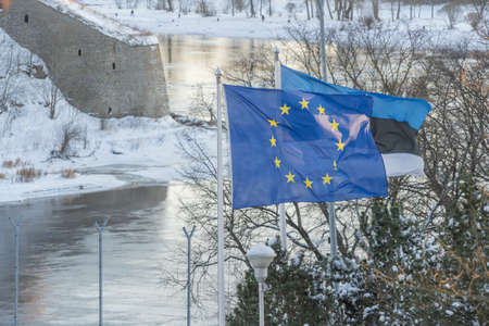 Narva Estonia. December 5, 2021 View of the waving flag of Estonia and Europe, on the border between Estonia and Russiaの写真素材