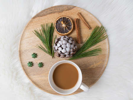 Sweet chocolate dessert in the shape of a cone on a wooden tray. on white background. Christmas treat.の写真素材