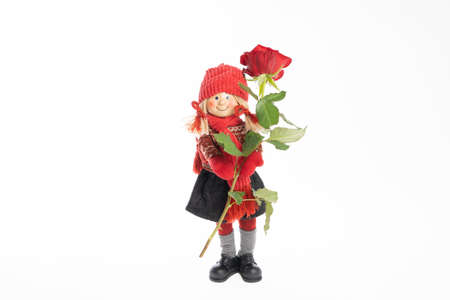 Doll, a girl with a flower with a rose, make a congratulation On a white background .Concept .Postcard for Valentine's Day, Friend's Day, February 14, mother's dayの写真素材