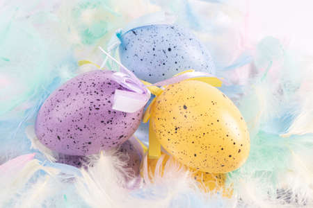 Easter colored eggs decorated with colored feathers. close-up. View from above