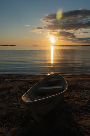 Seascape and a boat on the shore. Peaceful, calm, evening sky and sea. natural background. summer evening.の写真素材